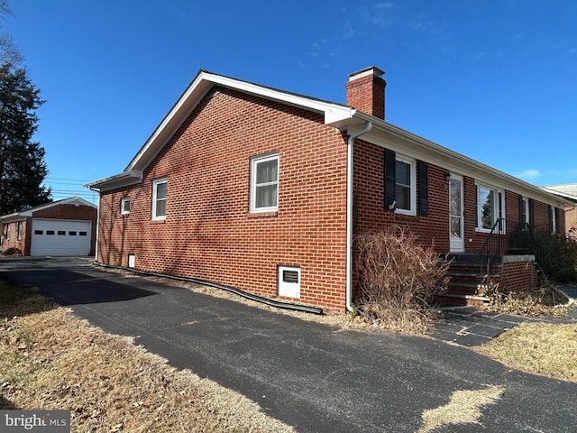 view of side of property with a garage and an outdoor structure