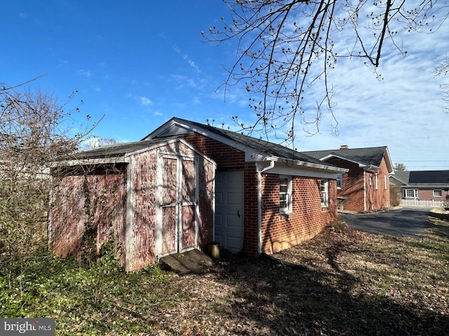 view of side of home with a storage unit