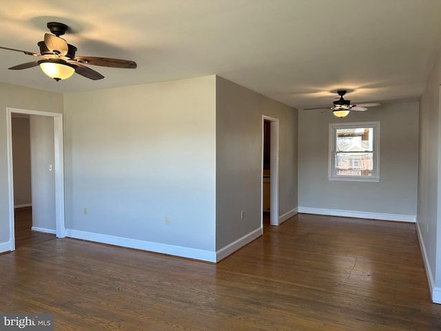 empty room featuring ceiling fan and dark hardwood / wood-style flooring