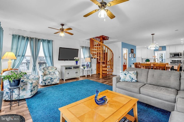 living room featuring ceiling fan and hardwood / wood-style floors