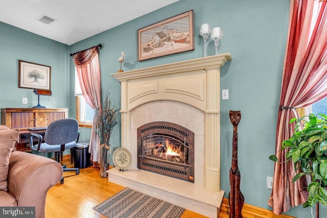 sitting room featuring a fireplace and light hardwood / wood-style flooring