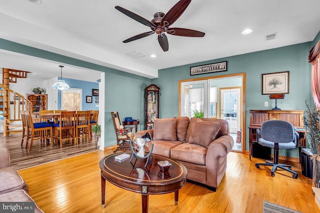 living room featuring ceiling fan and light hardwood / wood-style flooring