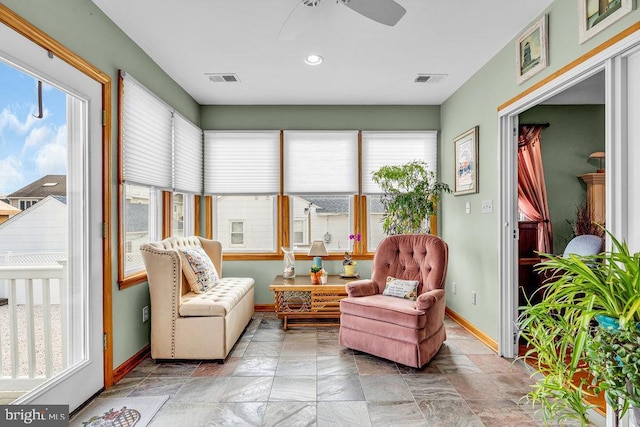 sunroom / solarium featuring ceiling fan