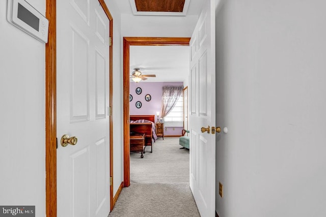 hallway featuring light colored carpet