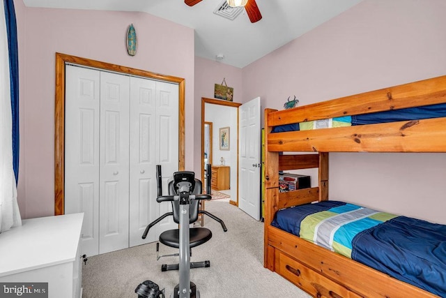 carpeted bedroom featuring vaulted ceiling, ceiling fan, and a closet