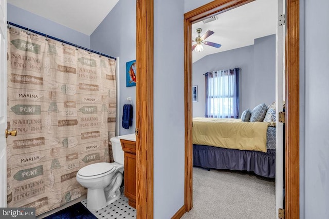 bathroom with toilet, vaulted ceiling, vanity, curtained shower, and ceiling fan