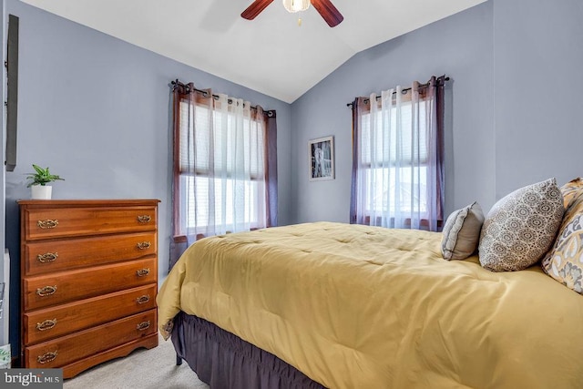 bedroom with lofted ceiling, ceiling fan, and carpet