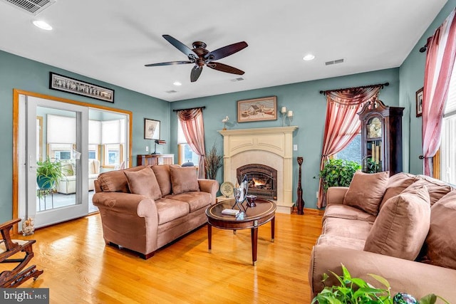 living room featuring ceiling fan and light hardwood / wood-style flooring