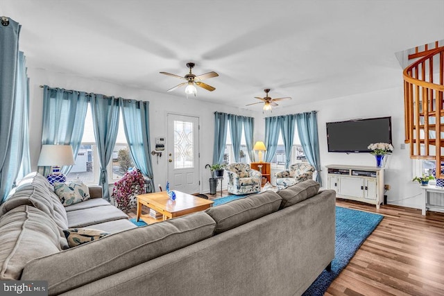 living room featuring hardwood / wood-style floors and ceiling fan