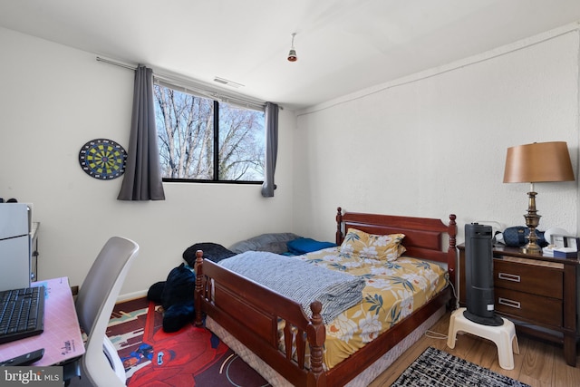 bedroom with hardwood / wood-style floors