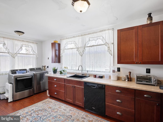 kitchen featuring washer and clothes dryer, light countertops, dark wood-type flooring, a sink, and dishwasher