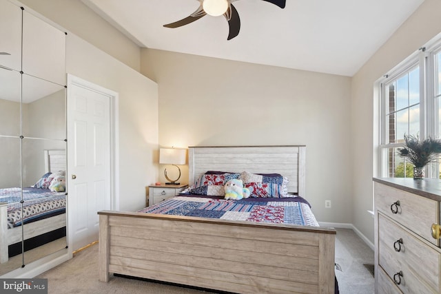 bedroom with light colored carpet and ceiling fan