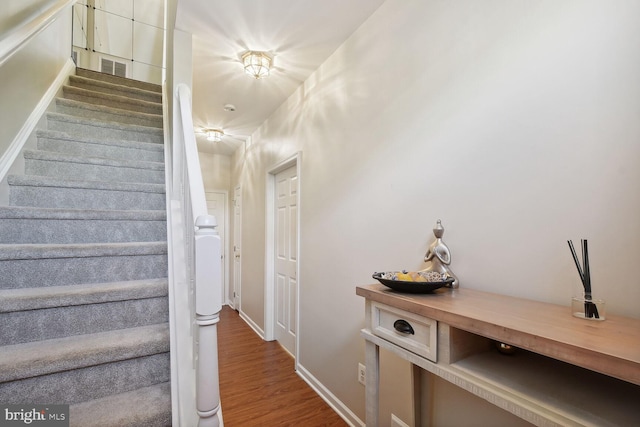 stairway featuring hardwood / wood-style flooring