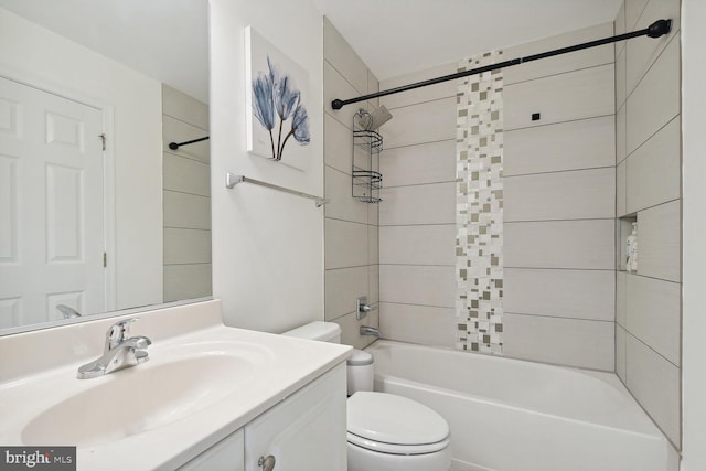 full bathroom featuring tiled shower / bath, vanity, and toilet