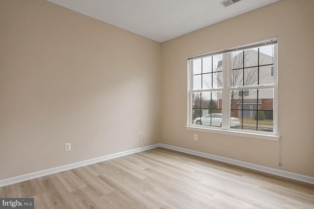 unfurnished room with light hardwood / wood-style floors