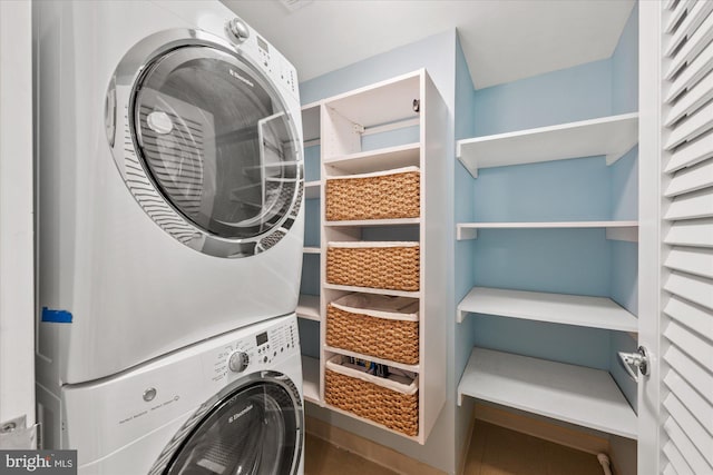 laundry area with stacked washer / dryer