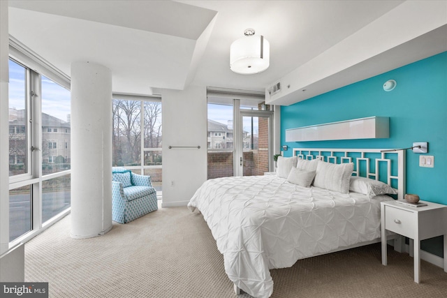 bedroom featuring a wall of windows and carpet