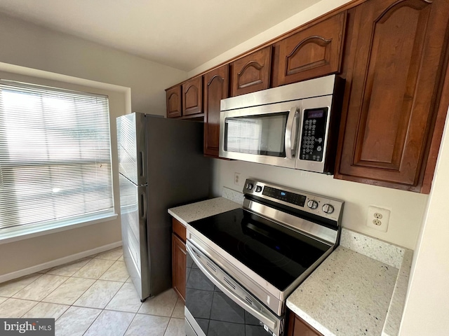 kitchen with light tile patterned floors and appliances with stainless steel finishes