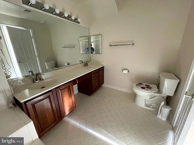 bathroom with tile patterned flooring, vanity, and toilet