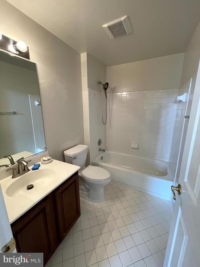 full bathroom featuring vanity, tile patterned flooring, toilet, and tiled shower / bath