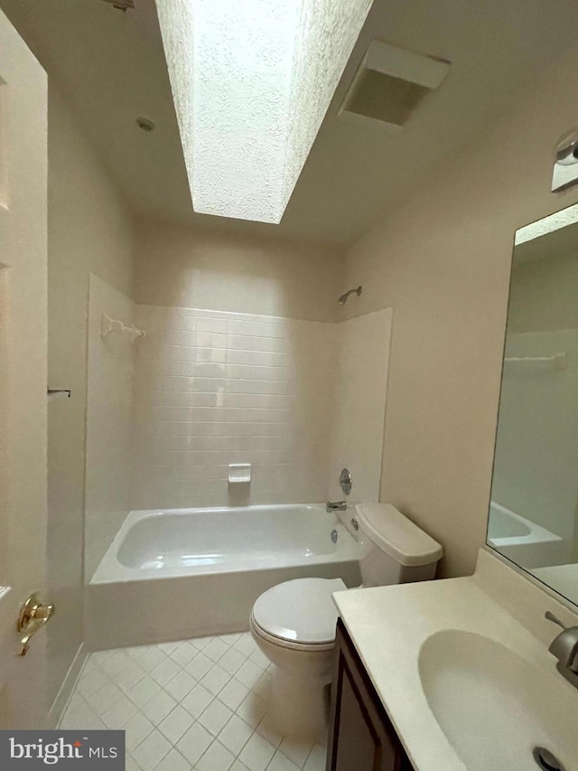 full bathroom featuring vanity, tile patterned floors, toilet, and tiled shower / bath