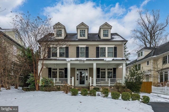 american foursquare style home with a porch and fence