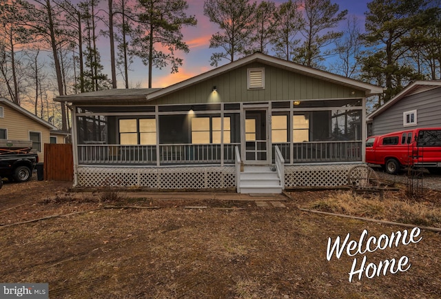 view of front of home featuring a sunroom