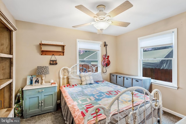 carpeted bedroom featuring ceiling fan and baseboards