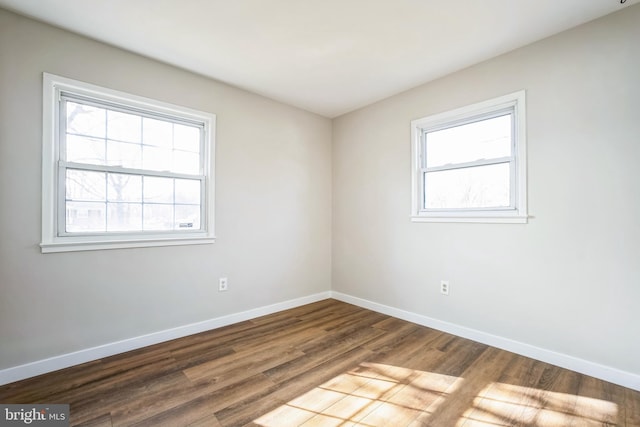 empty room with hardwood / wood-style flooring