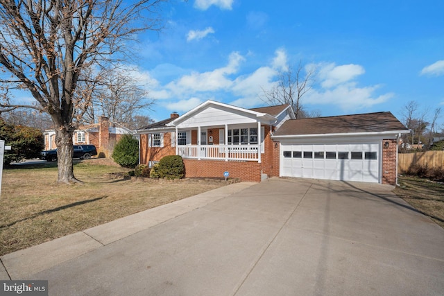 ranch-style home featuring a garage, covered porch, and a front lawn