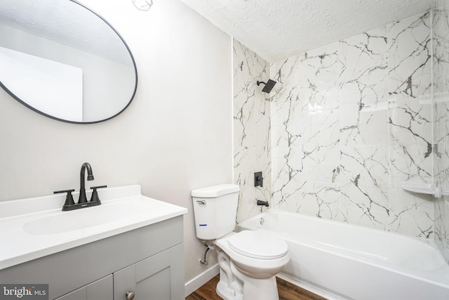 full bathroom with hardwood / wood-style floors, tiled shower / bath combo, vanity, a textured ceiling, and toilet