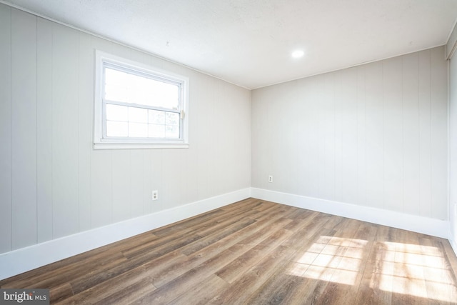 empty room with hardwood / wood-style floors