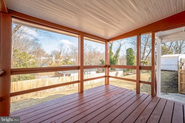 unfurnished sunroom with vaulted ceiling and a healthy amount of sunlight