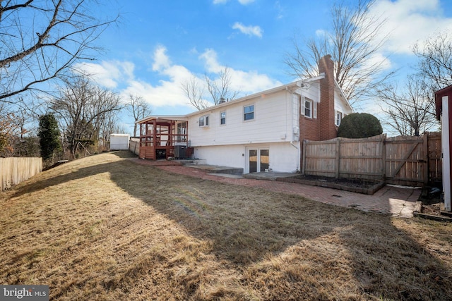 back of house with a yard and a deck