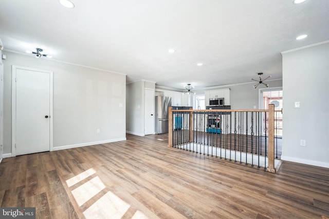 unfurnished living room featuring crown molding, ceiling fan, and light wood-type flooring