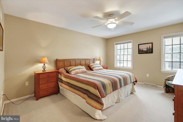 bedroom featuring light carpet and ceiling fan