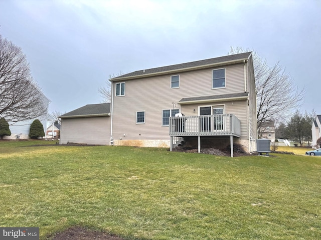 back of house with central AC unit, a deck, and a lawn