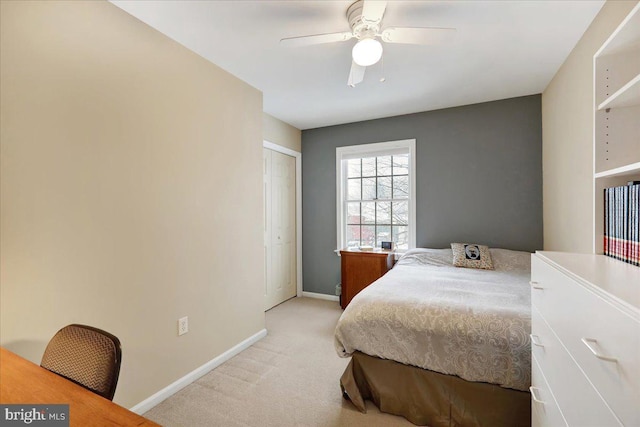 bedroom with light colored carpet, a closet, and ceiling fan