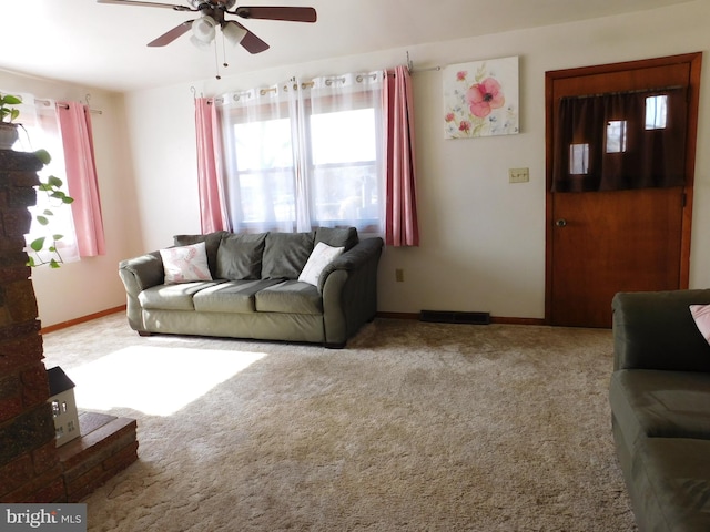 carpeted living room with ceiling fan