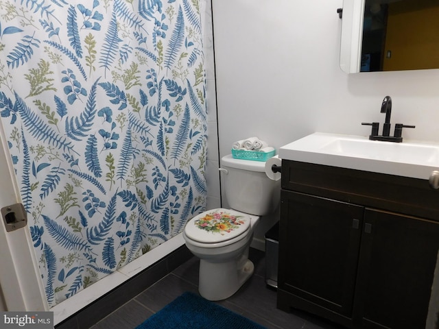 bathroom featuring vanity, curtained shower, tile patterned floors, and toilet