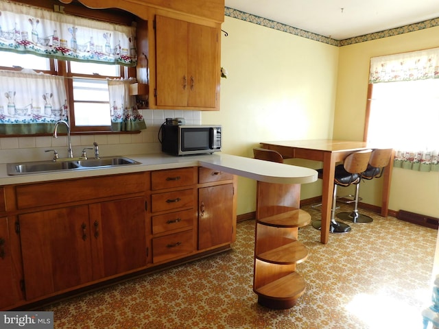 kitchen featuring sink and decorative backsplash