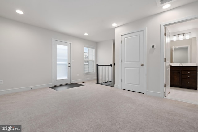 interior space featuring sink and light colored carpet