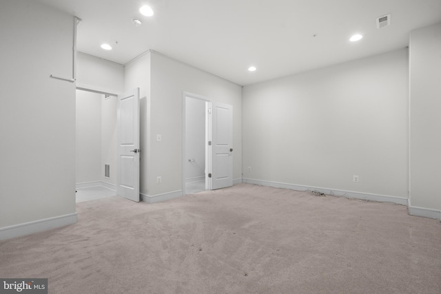 unfurnished bedroom featuring light colored carpet