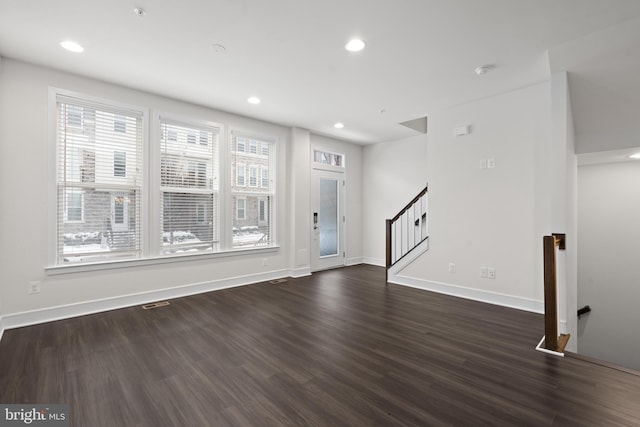 unfurnished living room featuring dark hardwood / wood-style flooring