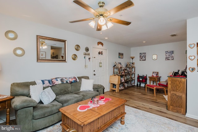 living room featuring ceiling fan and light hardwood / wood-style flooring