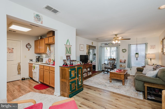 kitchen with ceiling fan and light hardwood / wood-style flooring