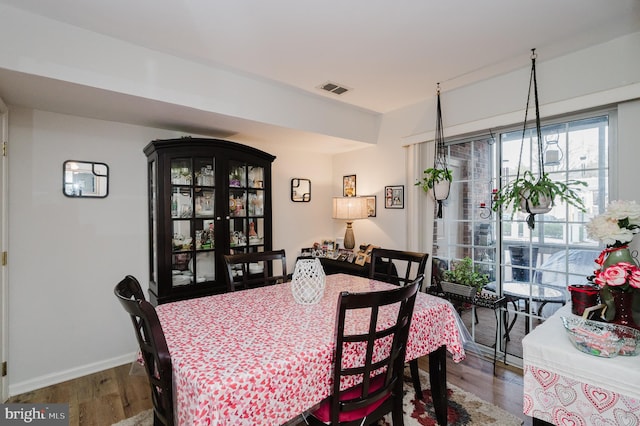 dining space with hardwood / wood-style floors