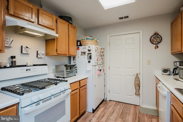 kitchen featuring white appliances and light hardwood / wood-style flooring