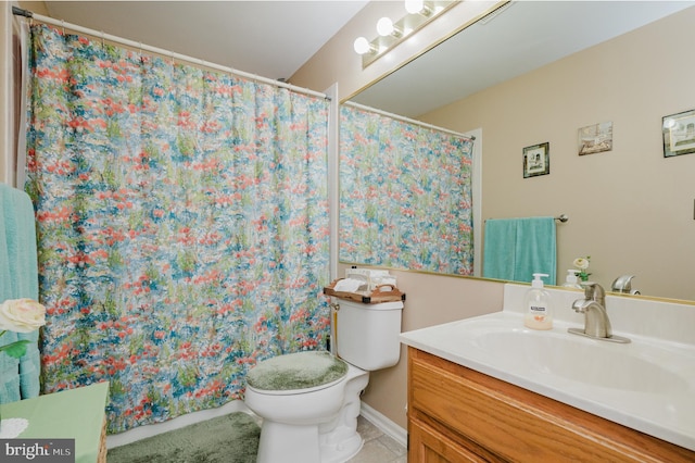 bathroom with tile patterned flooring, vanity, and toilet