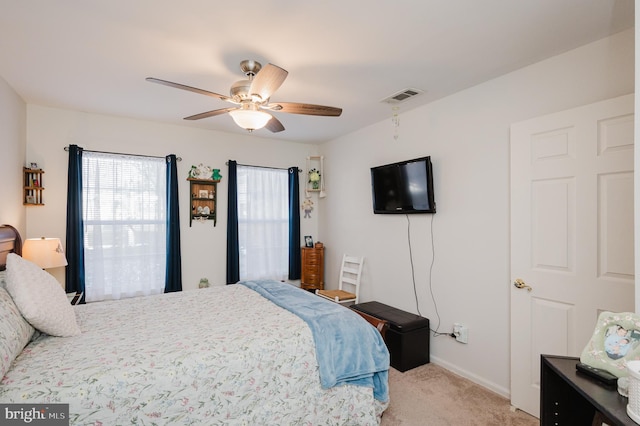 bedroom with light colored carpet and ceiling fan